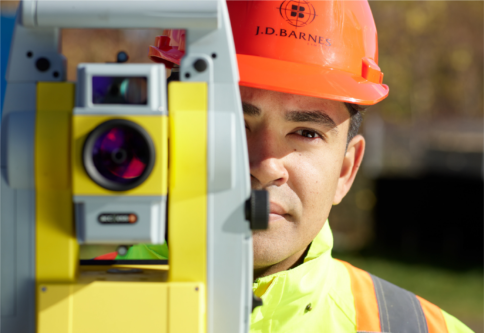 Surveyor close up looking through a tripod